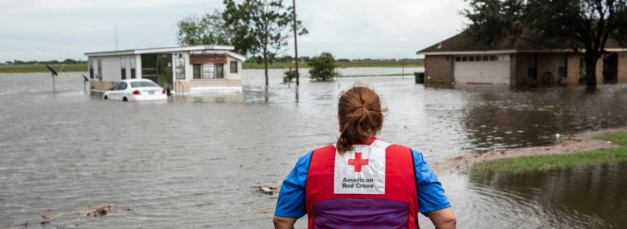 Volunteer looks at flood damage