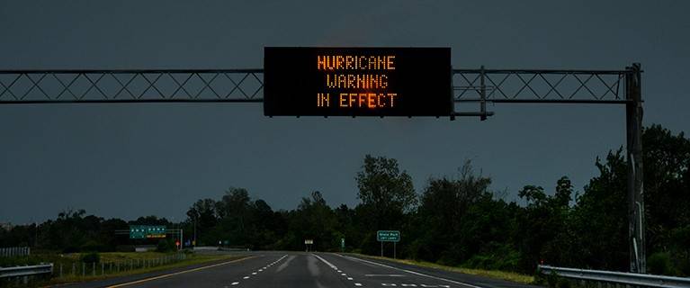 Hurricane warning lighted sign over a highway